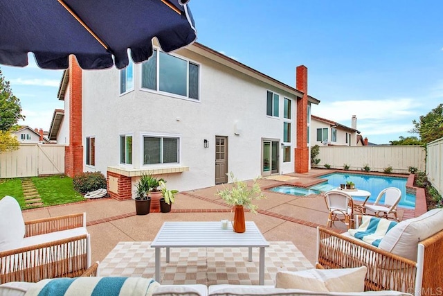 back of house with a patio area, a fenced backyard, an outdoor living space, and stucco siding