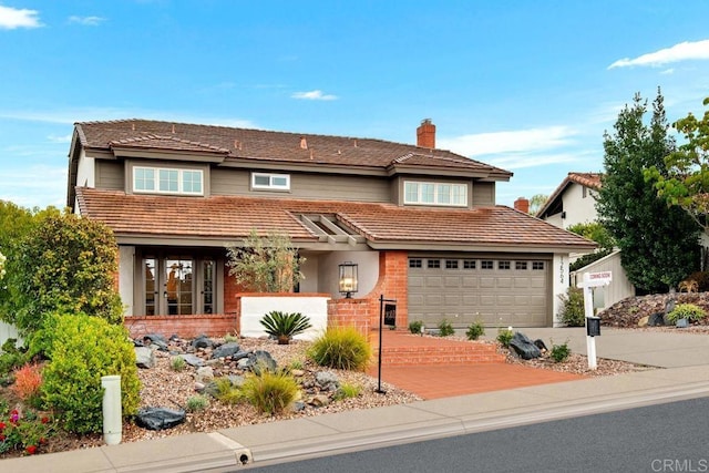 traditional home featuring a garage, brick siding, driveway, and a chimney