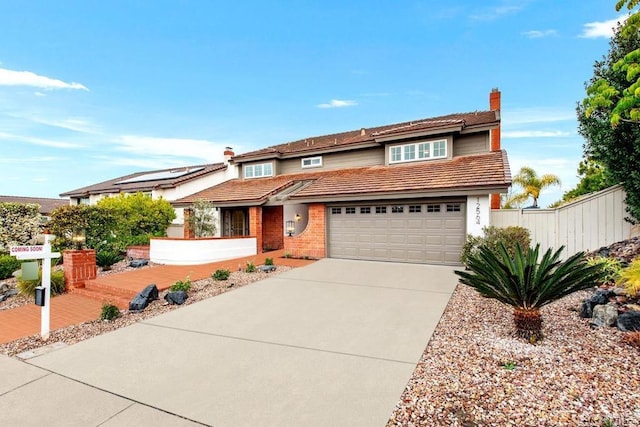 view of front of home with driveway, a chimney, a tiled roof, fence, and brick siding