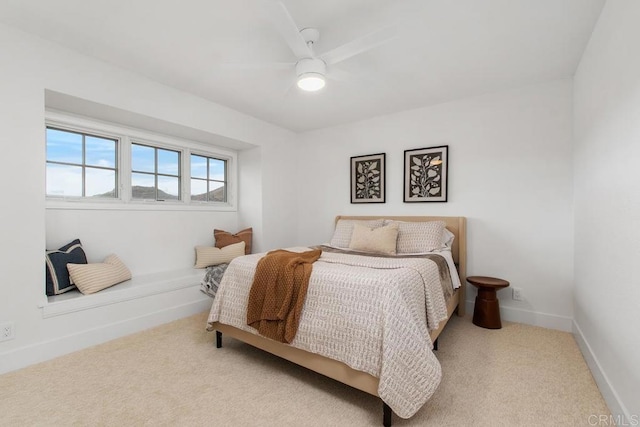 bedroom with ceiling fan, carpet flooring, and baseboards