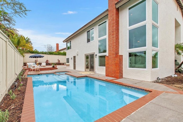 view of swimming pool with a patio area, a fenced backyard, and a fenced in pool