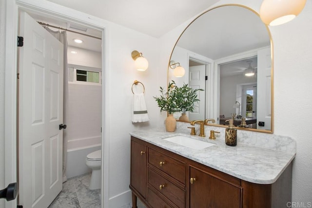 bathroom featuring toilet, marble finish floor, a washtub, and vanity