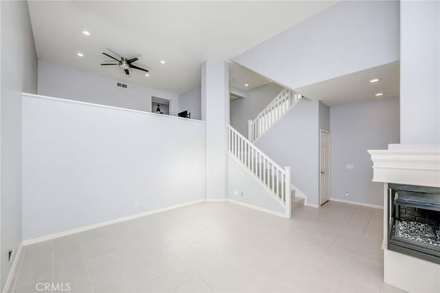 unfurnished living room with ceiling fan