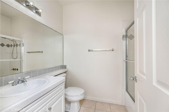 full bathroom with vanity, tile patterned floors, shower / bath combination with glass door, and toilet