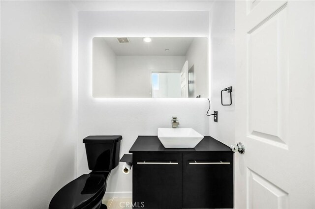 bathroom with vanity and toilet