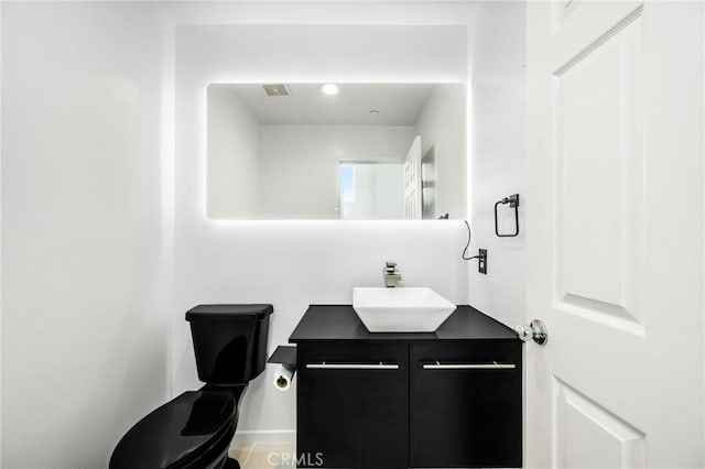 bathroom featuring toilet and vanity