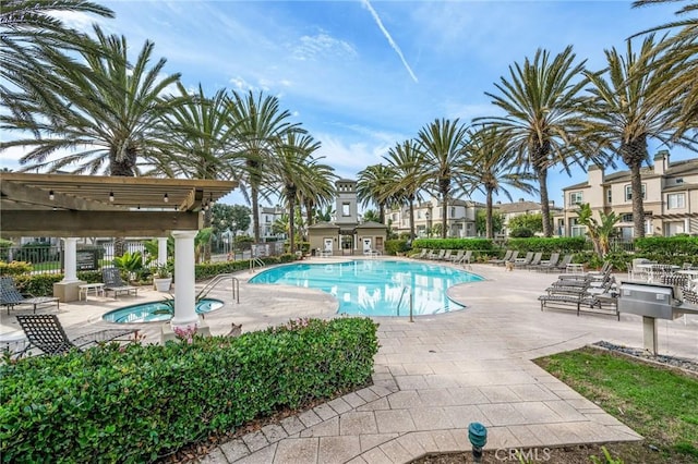 pool with a patio area and fence