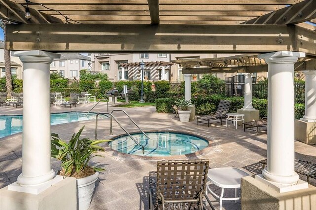 view of swimming pool featuring a hot tub, a patio, and a pergola