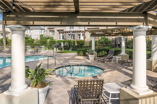 community pool with a patio, a pergola, and a hot tub