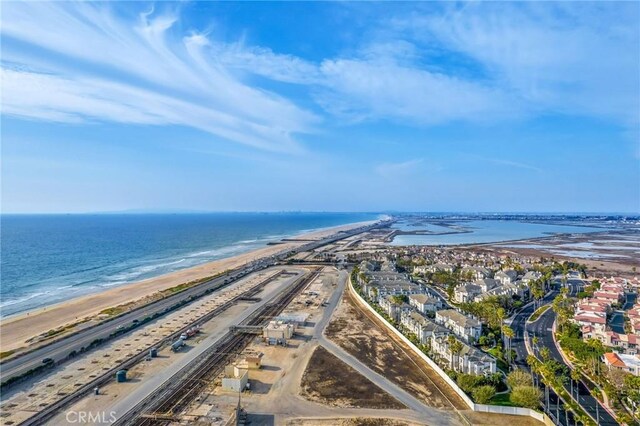 bird's eye view featuring a water view and a beach view