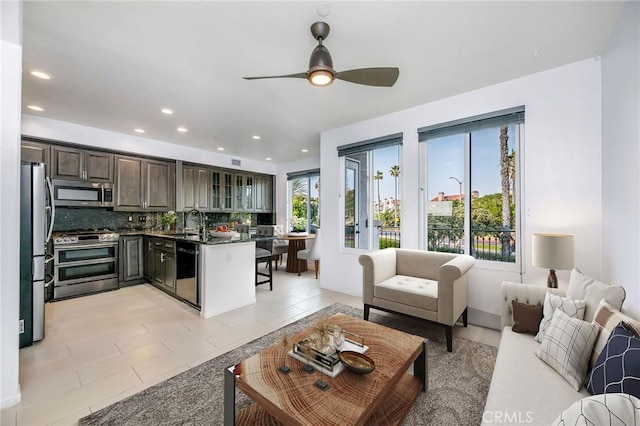 living area featuring light tile patterned floors, recessed lighting, and a ceiling fan