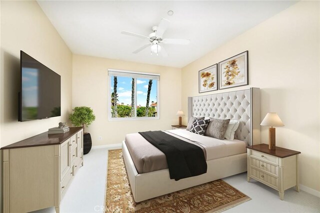 bedroom featuring a ceiling fan, light colored carpet, and baseboards