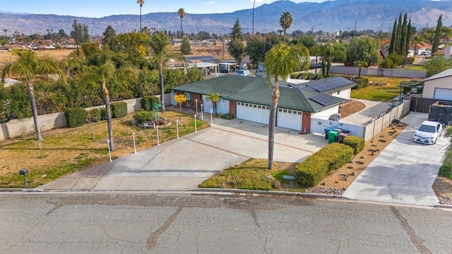 view of front of property with a garage and a mountain view