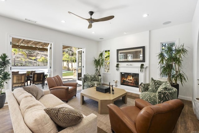 living room featuring hardwood / wood-style flooring and ceiling fan