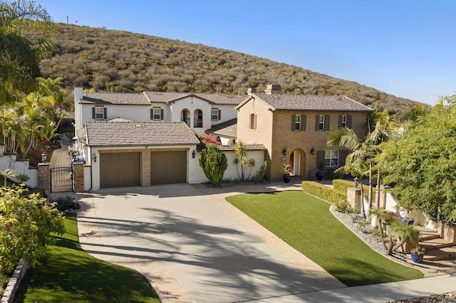 view of front of house with a garage and a front lawn