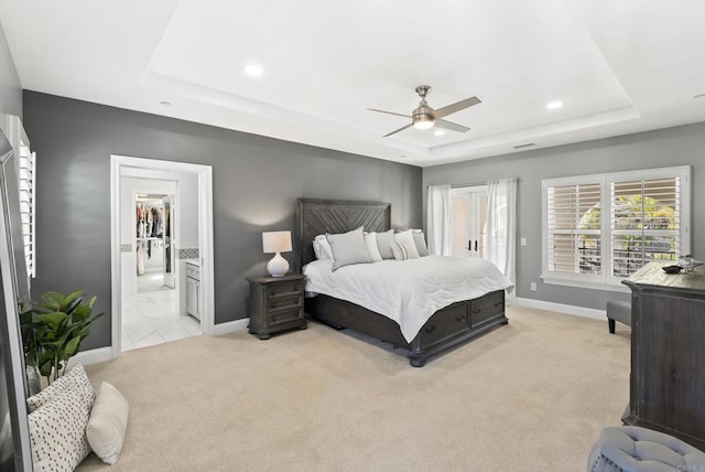 carpeted bedroom with access to outside, a raised ceiling, ceiling fan, and ensuite bathroom