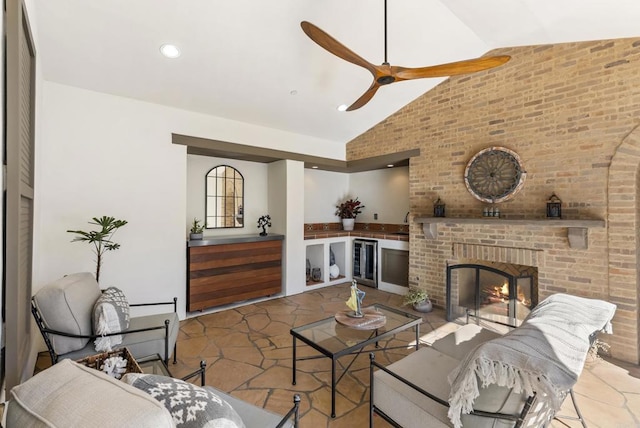 living room with wine cooler, ceiling fan, lofted ceiling, and a fireplace