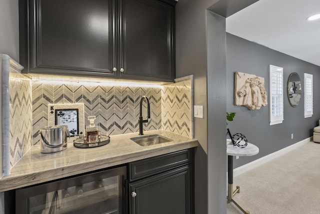 bar with tasteful backsplash, beverage cooler, sink, and light carpet