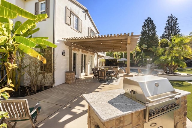 view of patio featuring an outdoor kitchen, a pergola, and area for grilling