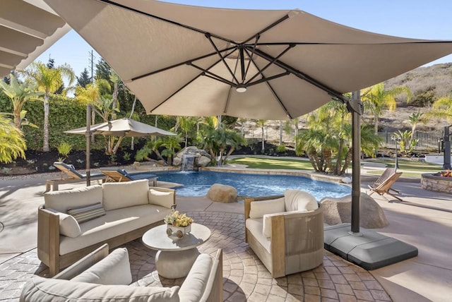 view of swimming pool featuring an outdoor living space, pool water feature, and a patio area