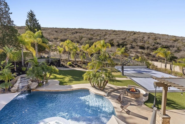 view of pool featuring an outdoor fire pit, a patio, and a lawn