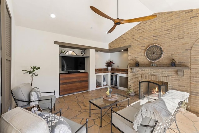 living room with vaulted ceiling, a brick fireplace, wine cooler, and ceiling fan