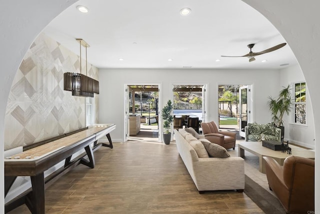 living room with ceiling fan and wood-type flooring