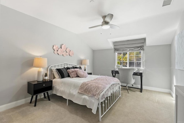 bedroom featuring light carpet, vaulted ceiling, and ceiling fan