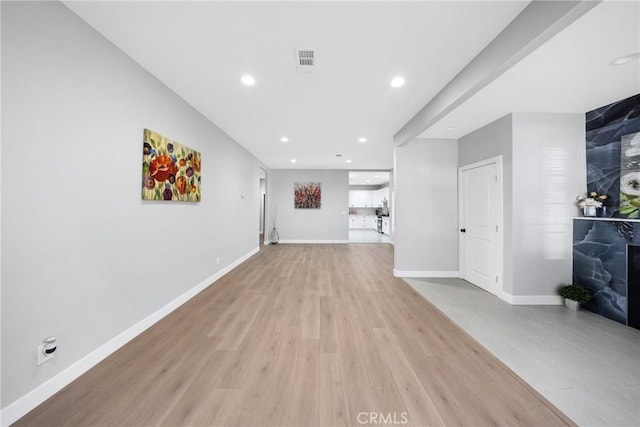 unfurnished living room with light hardwood / wood-style flooring and a fireplace