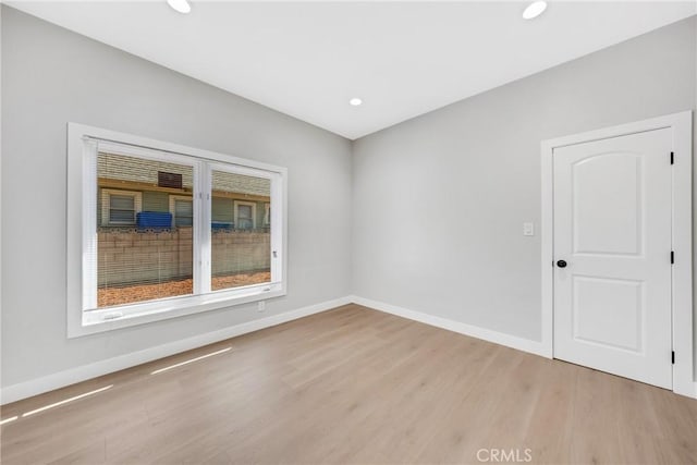 unfurnished room with light hardwood / wood-style flooring