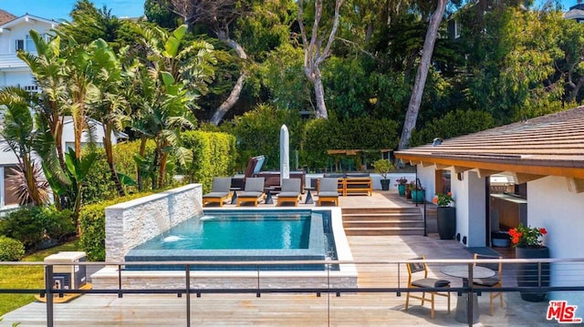 view of swimming pool featuring a deck