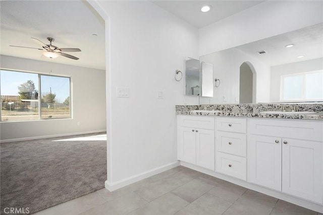 bathroom with vanity, ceiling fan, tile patterned flooring, and a healthy amount of sunlight