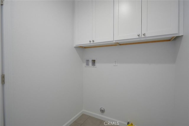 laundry room with cabinets, washer hookup, and light tile patterned floors