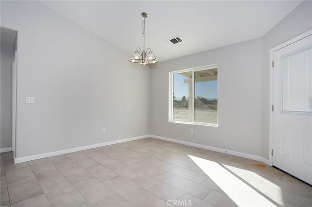 spare room featuring a notable chandelier