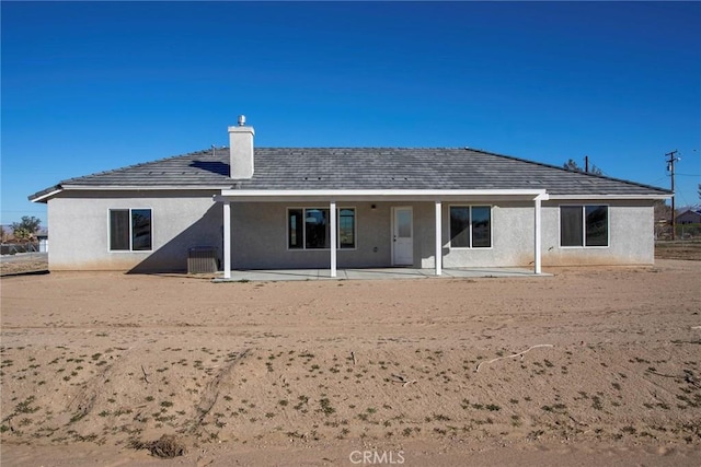 back of property with a patio