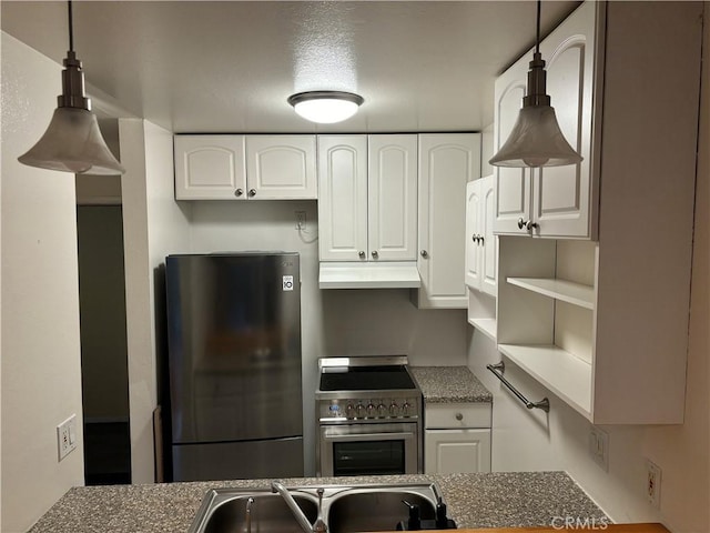 kitchen with appliances with stainless steel finishes, sink, pendant lighting, and white cabinets