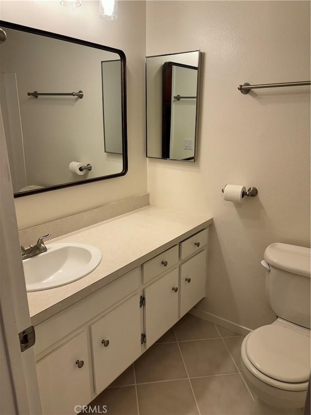 bathroom with vanity, tile patterned floors, and toilet