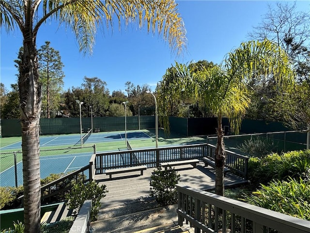 view of tennis court featuring fence