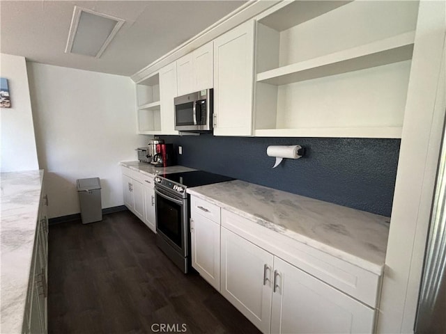 kitchen featuring dark wood-type flooring, stainless steel appliances, and white cabinets