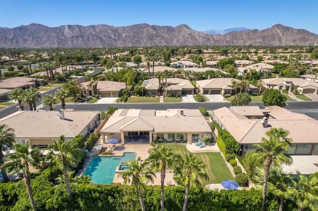 birds eye view of property with a mountain view