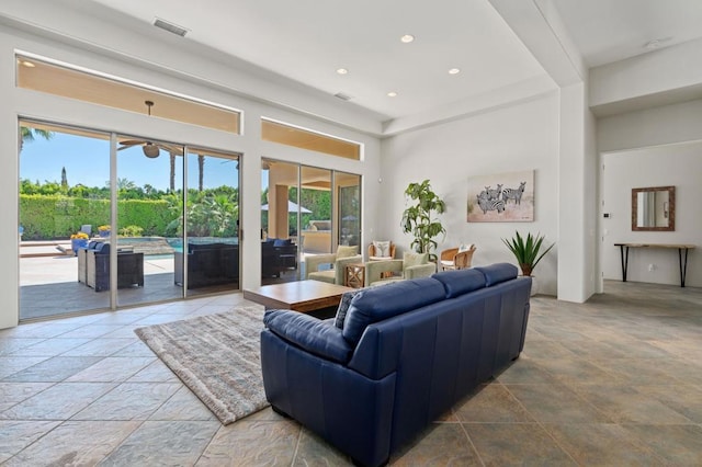 living room with a towering ceiling and plenty of natural light