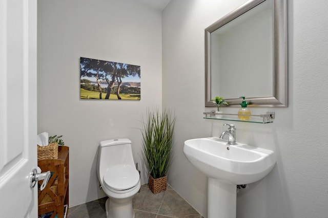 bathroom featuring tile patterned flooring and toilet