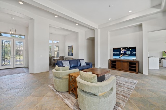 living room with french doors and a chandelier