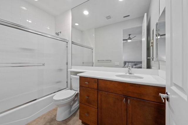 full bathroom featuring vanity, tile patterned flooring, enclosed tub / shower combo, and toilet