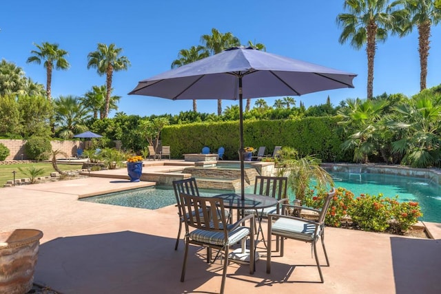 view of swimming pool with an in ground hot tub and a patio