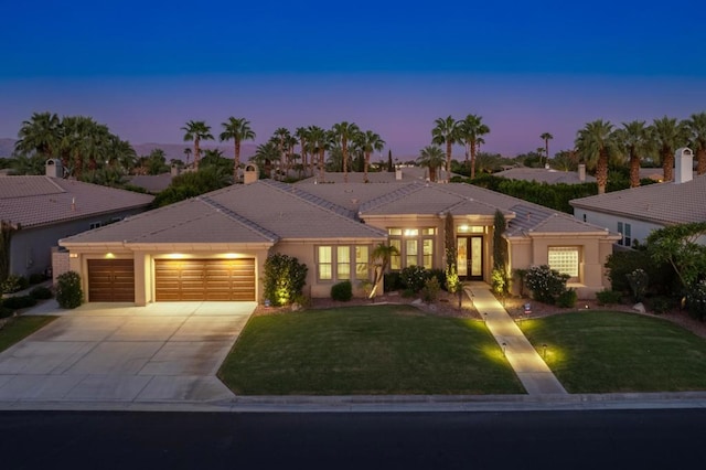 view of front of home featuring a yard and a garage