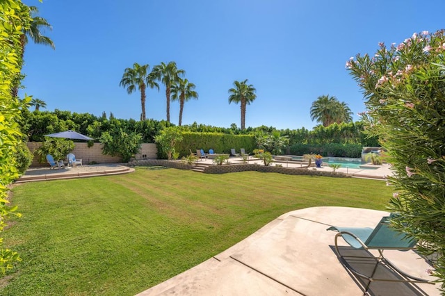 view of yard with a fenced in pool and a patio area