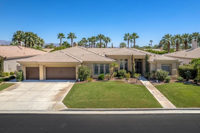 view of front of property featuring a garage and a front lawn