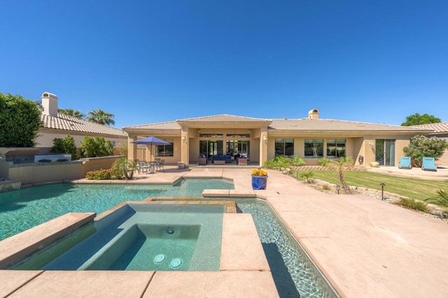 view of pool with an in ground hot tub and a patio area