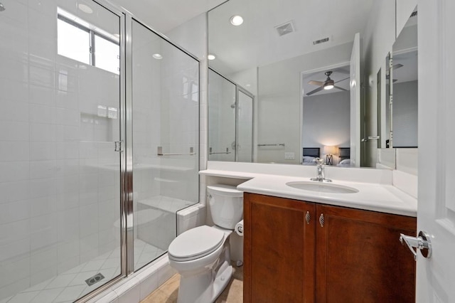 bathroom with vanity, ceiling fan, toilet, and walk in shower